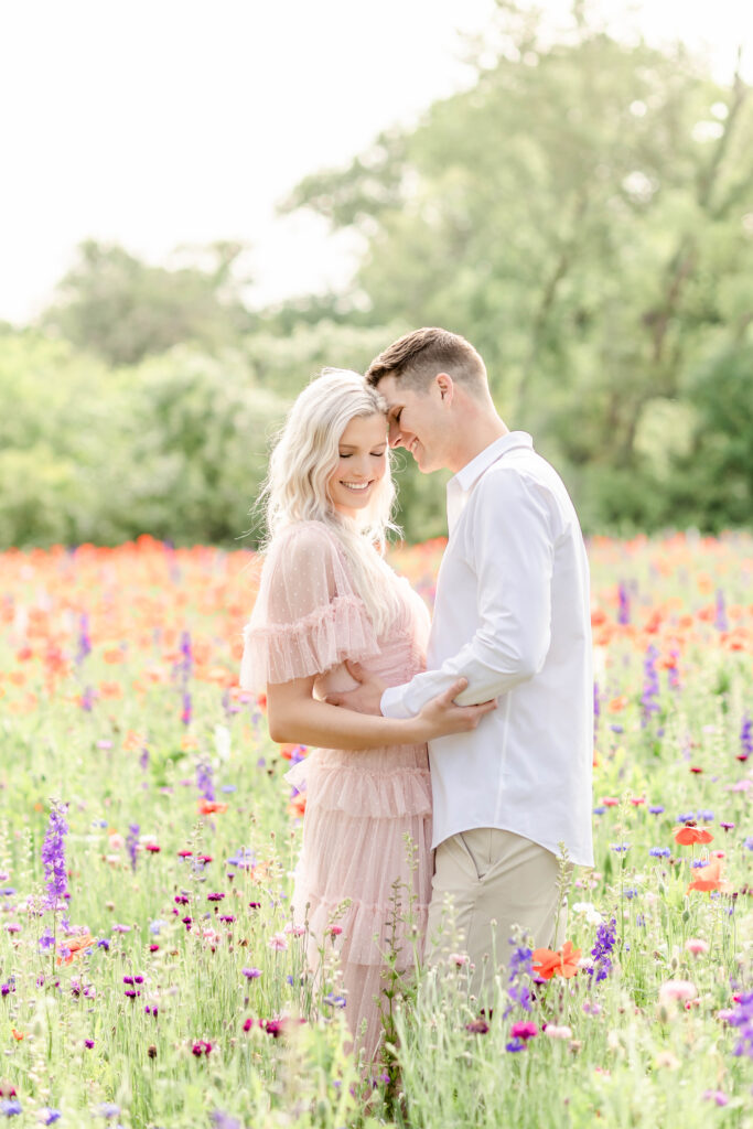couple embracing at the wildflower field at crowley park in richardson texas